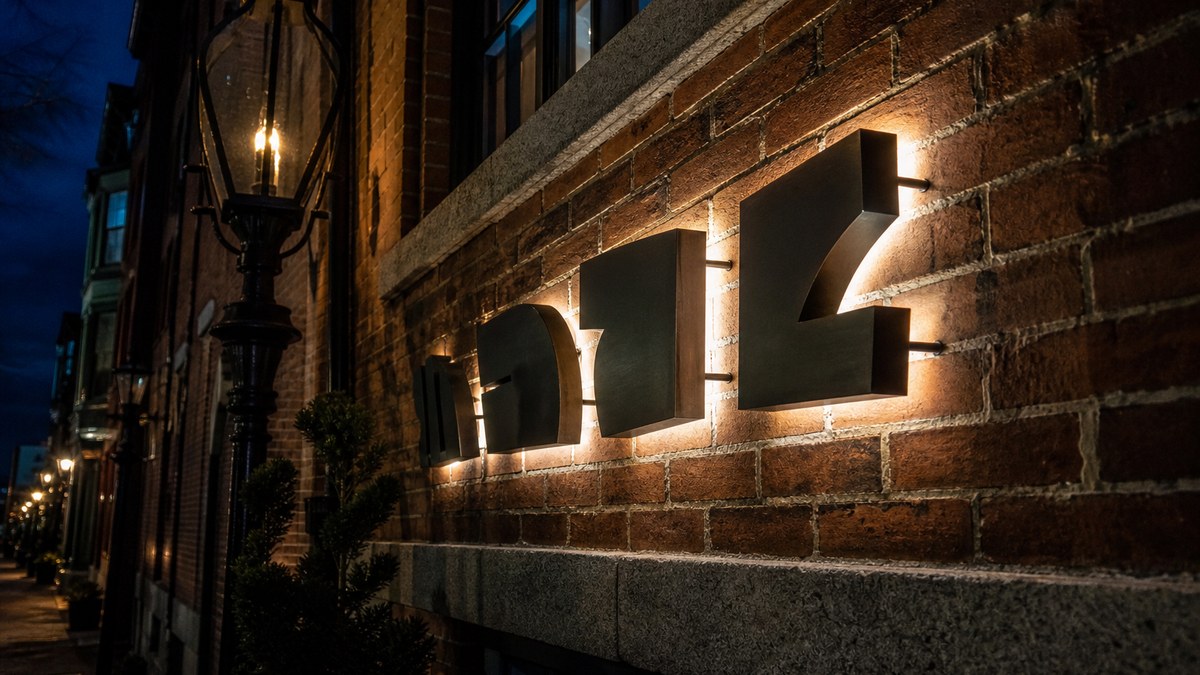Halo-lit LED channel letters on a historic brick building in Boston Massachusetts at night